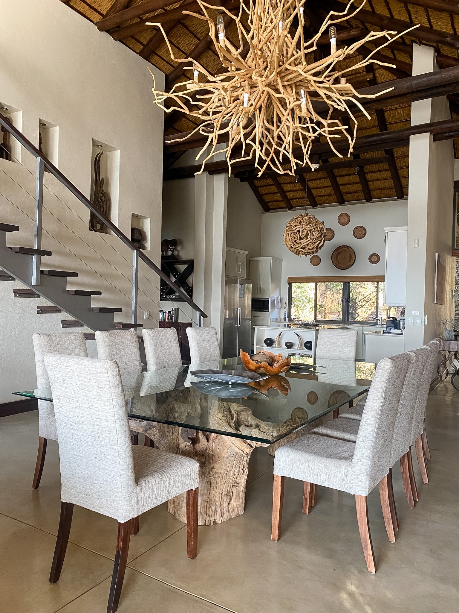 Dining area with driftwood chandelier and thatch above