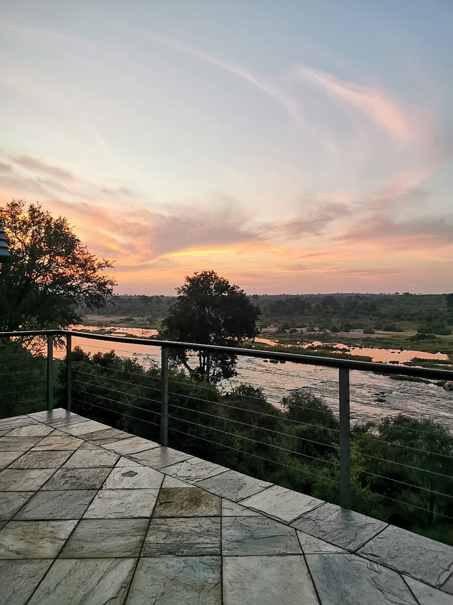 Terrace with lounge seating overlooking the river